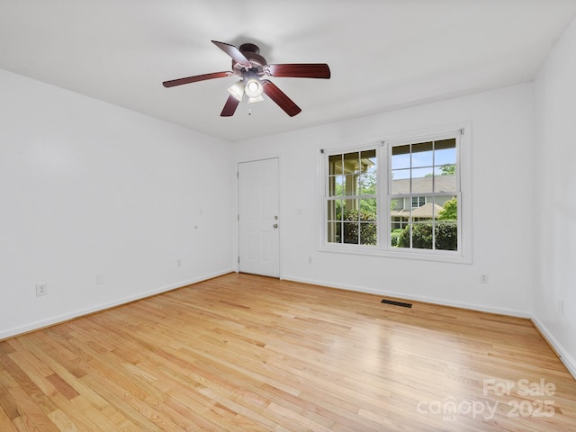 unfurnished room with wood finished floors, ceiling fan, and baseboards