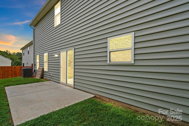 687 Cape Fear St, Fort Mill, SC 29715 - back of house at dusk with central air condition unit, a patio, and fence