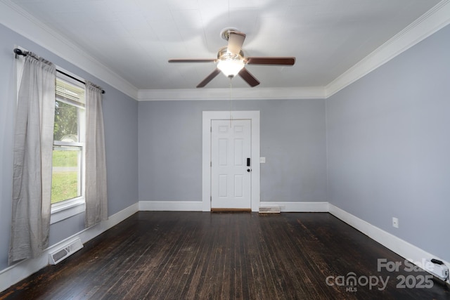 unfurnished room featuring dark wood-style flooring, ceiling fan, crown molding, and baseboards