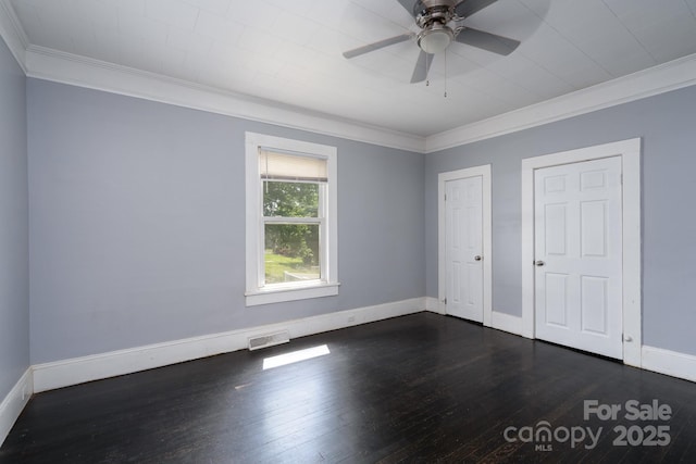 unfurnished bedroom with ornamental molding, dark wood-style flooring, and baseboards