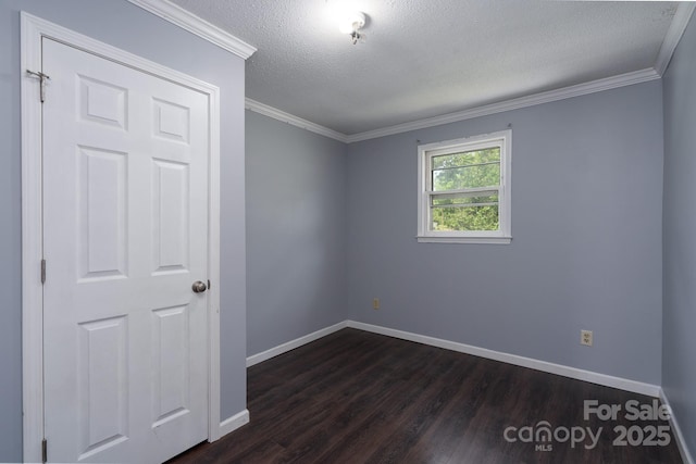 unfurnished room with dark wood-style flooring, baseboards, a textured ceiling, and ornamental molding