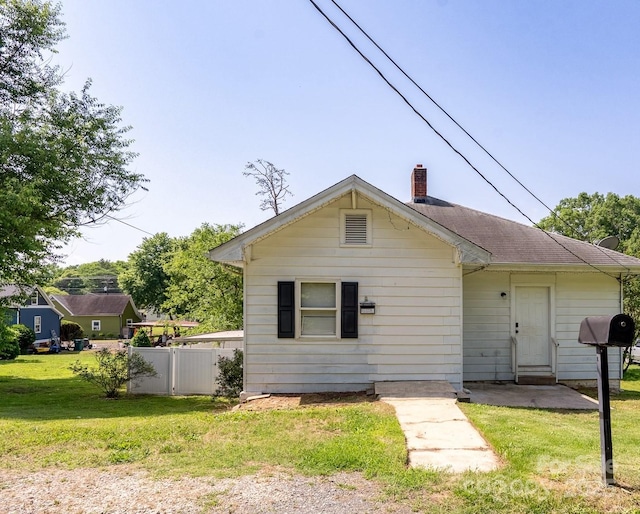 view of front of home featuring a chimney