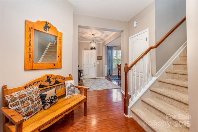 entrance foyer featuring stairway, wood finished floors, and baseboards