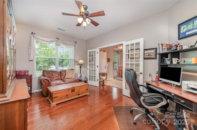 office space featuring wood finished floors, french doors, ceiling fan, and baseboards