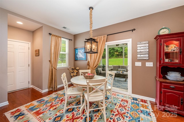 dining space featuring a chandelier, wood finished floors, baseboards, and recessed lighting