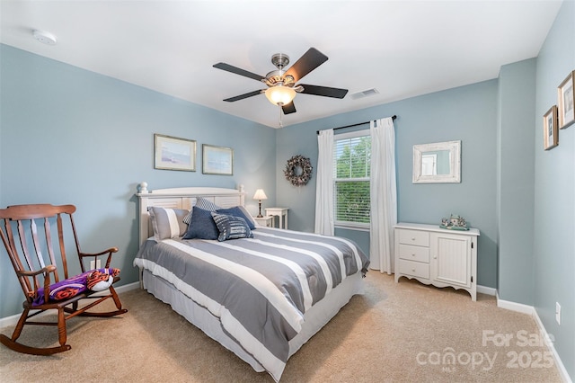 bedroom with light colored carpet, baseboards, and ceiling fan