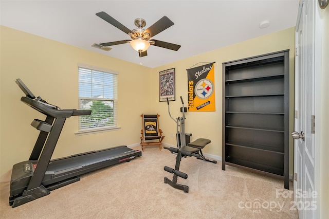 exercise area featuring a ceiling fan, carpet, and baseboards