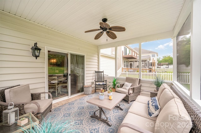 sunroom featuring outdoor lounge area and a ceiling fan