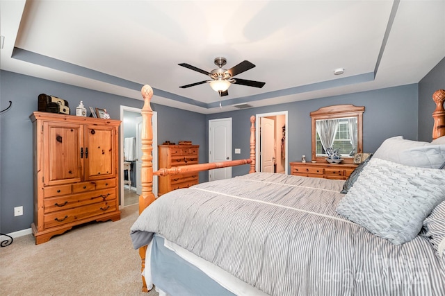12832 Heath Grove Dr, Huntersville, NC 28078 - bedroom featuring a tray ceiling, light colored carpet, baseboards, a ceiling fan, and ensuite bathroom