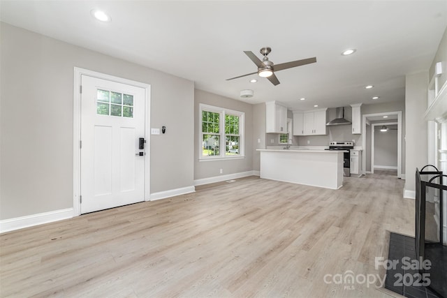 3920 Admiral Ave, Charlotte, NC 28205 - unfurnished living room featuring a ceiling fan, light wood-style floors, baseboards, recessed lighting, and a sink