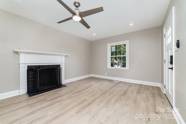 3920 Admiral Ave, Charlotte, NC 28205 - unfurnished living room with wood finished floors, ceiling fan, a fireplace, baseboards, and recessed lighting