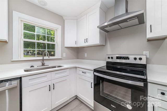 3920 Admiral Ave, Charlotte, NC 28205 - kitchen with stainless steel appliances, wall chimney exhaust hood, a sink, light countertops, and white cabinets