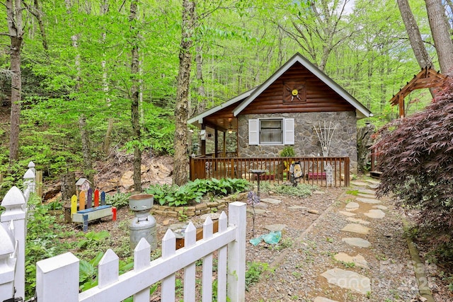 751 Millers Pond Ln, Boone, NC 28607 - view of front of house featuring stone siding, a wooden deck, and a view of trees