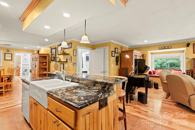 751 Millers Pond Ln, Boone, NC 28607 - kitchen featuring open floor plan, a center island with sink, white dishwasher, crown molding, and a kitchen bar