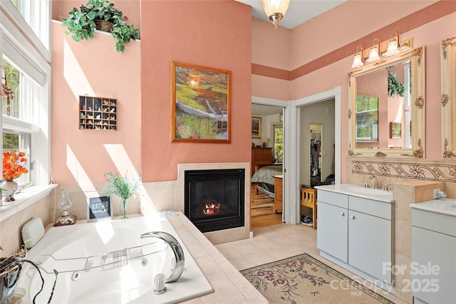 751 Millers Pond Ln, Boone, NC 28607 - ensuite bathroom featuring a tile fireplace, a garden tub, vanity, tile patterned flooring, and a high ceiling