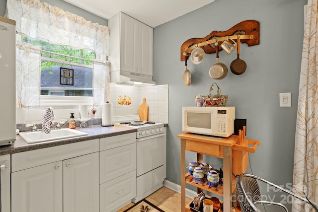 751 Millers Pond Ln, Boone, NC 28607 - kitchen with white appliances, white cabinets, tasteful backsplash, light tile patterned floors, and dark countertops