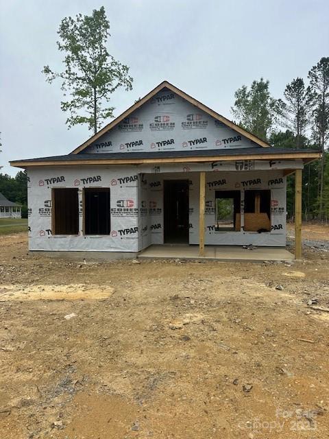 unfinished property featuring covered porch