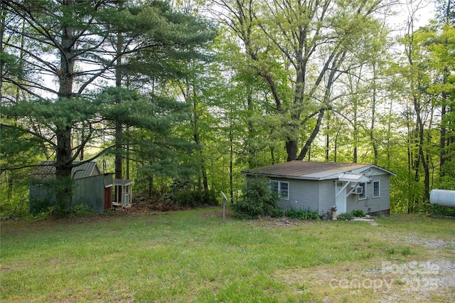 120 Powderhorn Dr, Burnsville, NC 28714 - view of green lawn with an outdoor structure and a wooded view