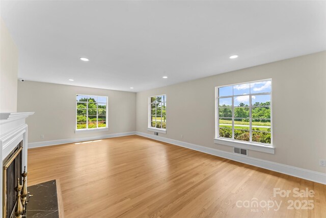 90 Pinewood Rd, Granite Falls, NC 28630 - unfurnished living room featuring light wood-type flooring, a high end fireplace, baseboards, and recessed lighting