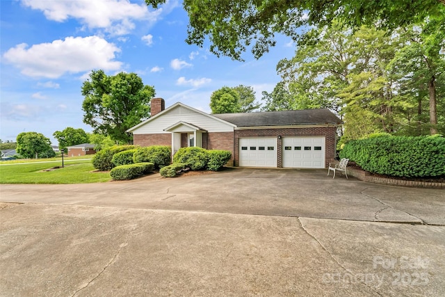90 Pinewood Rd, Granite Falls, NC 28630 - view of front of home featuring concrete driveway, an attached garage, brick siding, and a chimney