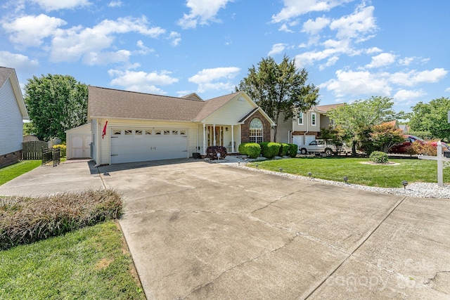 traditional-style home featuring driveway, a garage, a front lawn, and roof with shingles