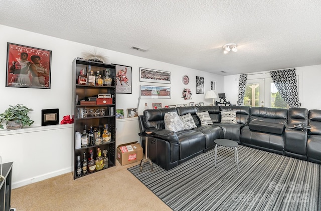 carpeted living area with a textured ceiling