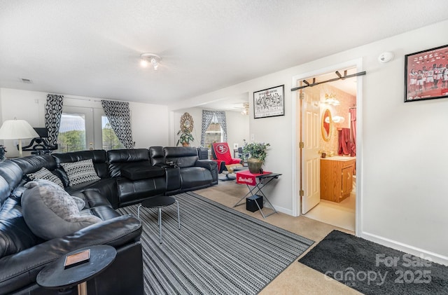 1076 Braxton Dr, Concord, NC 28025 - carpeted living room featuring plenty of natural light, french doors, and a textured ceiling