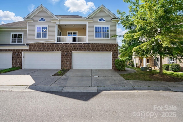 11209 Lazio Ln Unit 1, Charlotte, NC 28277 - view of front of house featuring brick siding, concrete driveway, and a garage