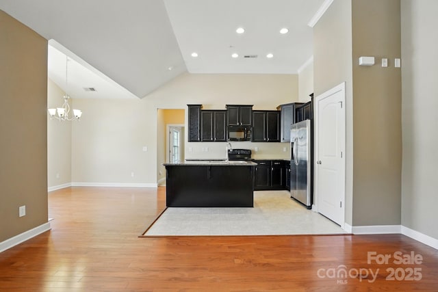 11209 Lazio Ln Unit 1, Charlotte, NC 28277 - kitchen with black appliances, a chandelier, dark cabinets, open floor plan, and high vaulted ceiling