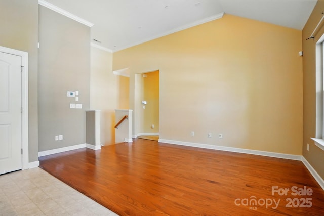 11209 Lazio Ln Unit 1, Charlotte, NC 28277 - empty room featuring ornamental molding, baseboards, vaulted ceiling, and wood finished floors