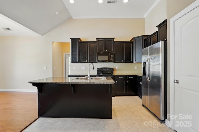 11209 Lazio Ln Unit 1, Charlotte, NC 28277 - kitchen with black appliances, a sink, stone countertops, a kitchen island with sink, and a breakfast bar