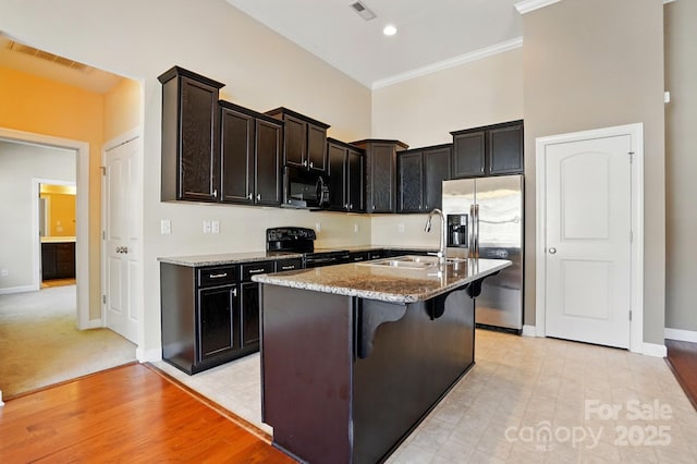 11209 Lazio Ln Unit 1, Charlotte, NC 28277 - kitchen with black appliances, a sink, light stone counters, baseboards, and ornamental molding