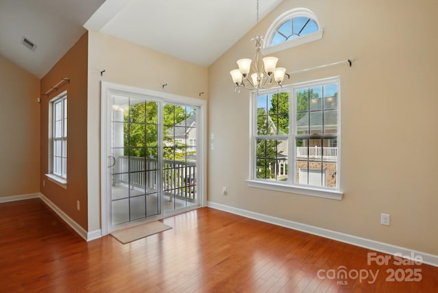 11209 Lazio Ln Unit 1, Charlotte, NC 28277 - doorway to outside featuring a chandelier, hardwood / wood-style flooring, baseboards, and high vaulted ceiling