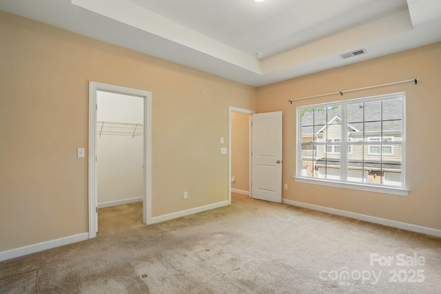 11209 Lazio Ln Unit 1, Charlotte, NC 28277 - unfurnished bedroom with carpet, a tray ceiling, baseboards, a spacious closet, and a closet
