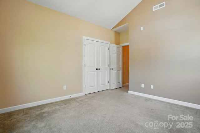 11209 Lazio Ln Unit 1, Charlotte, NC 28277 - unfurnished bedroom featuring carpet flooring, baseboards, high vaulted ceiling, and a closet