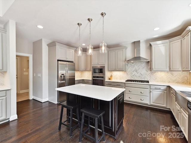 129 Overlook Ridge Ln, Davidson, NC 28036 - kitchen featuring stainless steel appliances, wall chimney range hood, a breakfast bar, tasteful backsplash, and a center island