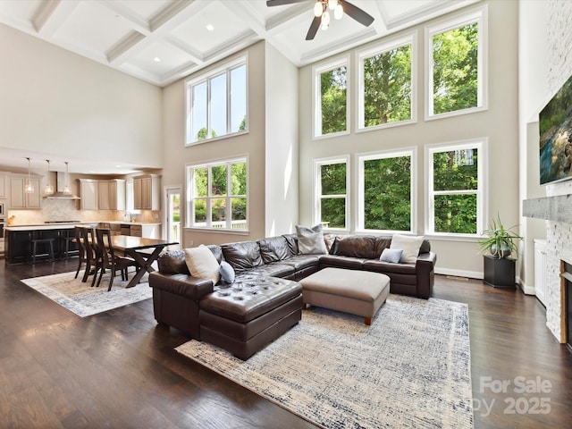 129 Overlook Ridge Ln, Davidson, NC 28036 - living room featuring a towering ceiling, a fireplace, ceiling fan, coffered ceiling, and beamed ceiling