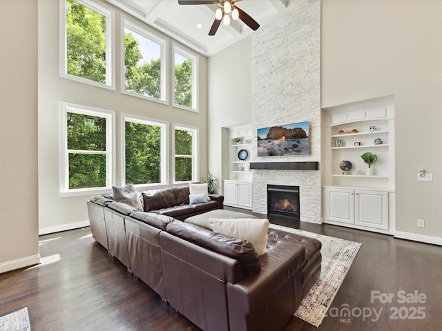 129 Overlook Ridge Ln, Davidson, NC 28036 - living area featuring a high ceiling, baseboards, a ceiling fan, plenty of natural light, and a fireplace