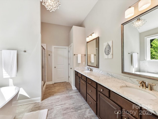 129 Overlook Ridge Ln, Davidson, NC 28036 - bathroom with a chandelier, a freestanding bath, double vanity, and a stall shower