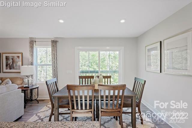 dining room with wood finished floors, recessed lighting, and baseboards