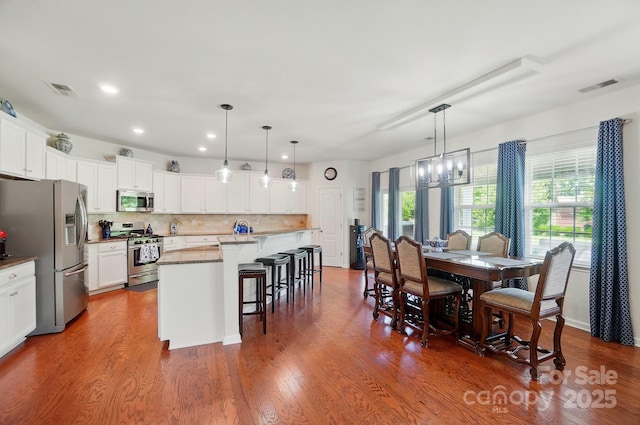 14316 Baytown Ct, Huntersville, NC 28078 - dining space featuring recessed lighting, a chandelier, and dark wood-type flooring