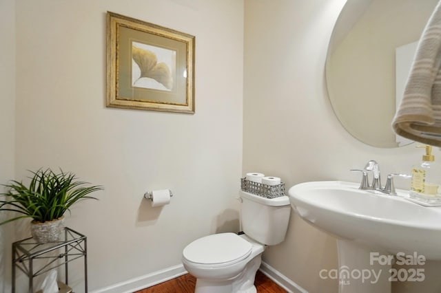 14316 Baytown Ct, Huntersville, NC 28078 - half bathroom featuring baseboards, wood finished floors, toilet, and a sink