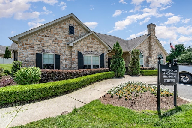 5214 Polo Gate Blvd, Charlotte, NC 28216 - french country style house with stone siding and a chimney