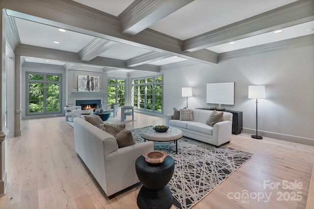 4920 Parview Dr S, Charlotte, NC 28226 - living area featuring beam ceiling, crown molding, a lit fireplace, plenty of natural light, and baseboards