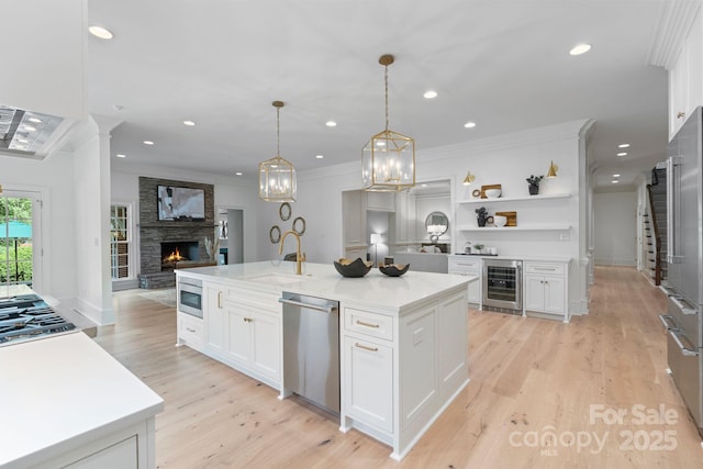 4920 Parview Dr S, Charlotte, NC 28226 - kitchen featuring stainless steel appliances, a sink, beverage cooler, ornamental molding, and a fireplace