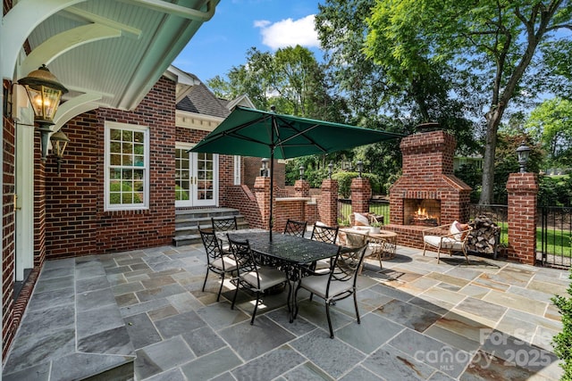 4920 Parview Dr S, Charlotte, NC 28226 - view of patio featuring an outdoor brick fireplace and french doors