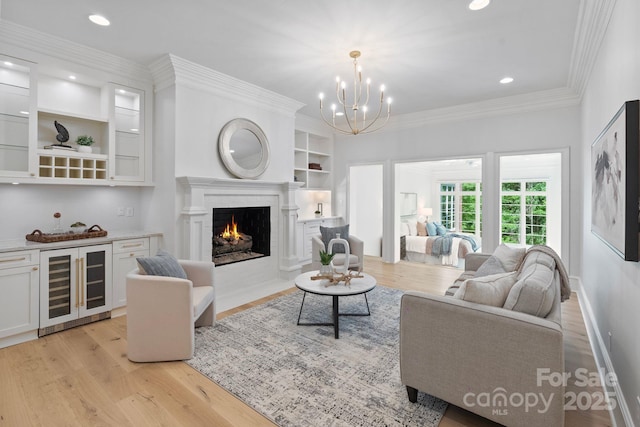 4920 Parview Dr S, Charlotte, NC 28226 - living area featuring wine cooler, light wood-style flooring, a fireplace with flush hearth, built in features, and a chandelier