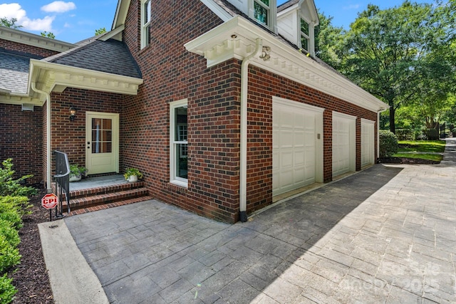 4920 Parview Dr S, Charlotte, NC 28226 - view of property exterior with brick siding, an attached garage, asphalt driveway, and a shingled roof