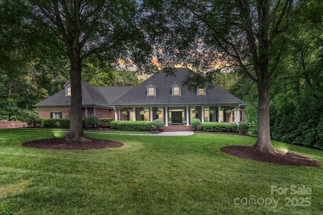 4920 Parview Dr S, Charlotte, NC 28226 - cape cod house with covered porch, a front yard, and brick siding
