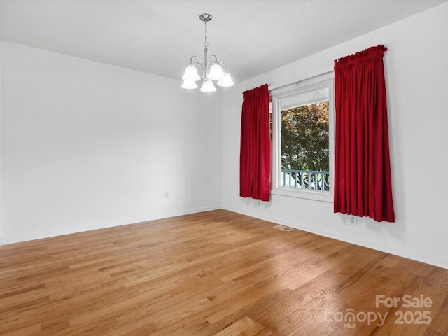 1028 Swaying Oats Dr, York, SC 29745 - empty room with a chandelier, light wood-style flooring, and baseboards